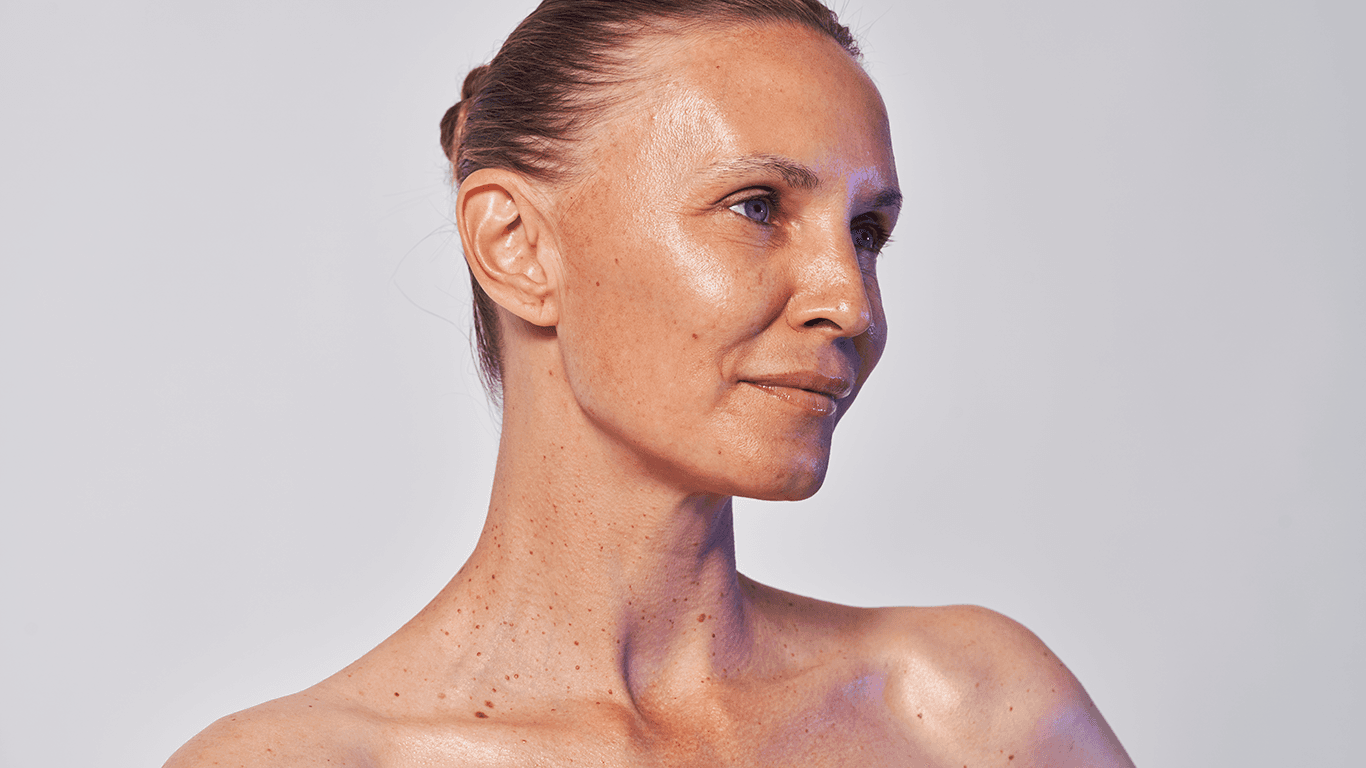 Woman in her 40s with healthy glowing skin showing natural firmness and smooth texture