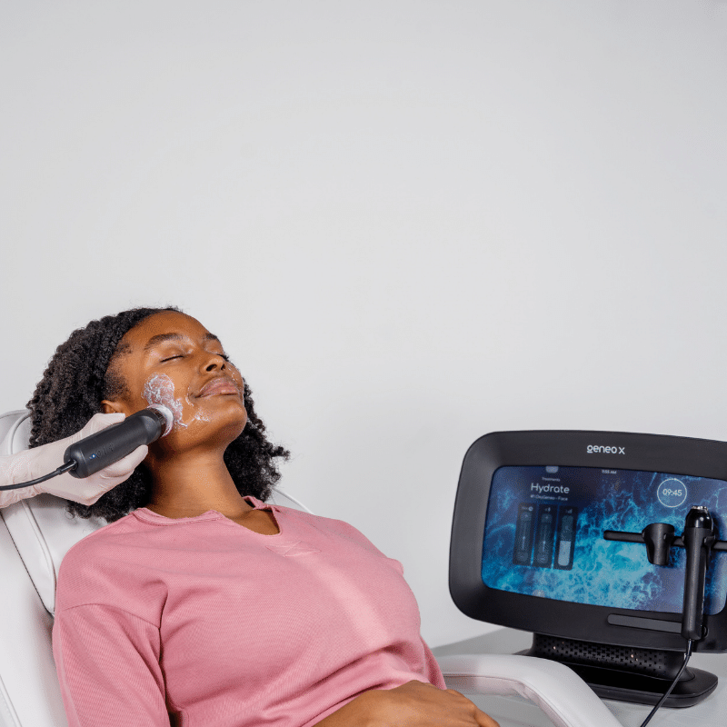 Woman receiving Geneo Hydrate facial treatment with Geneo X device