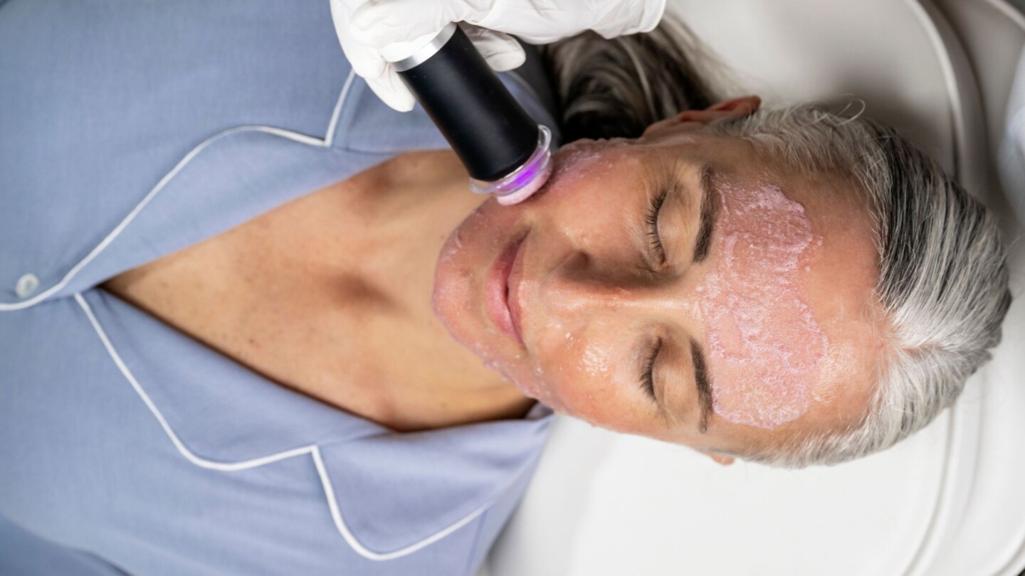 Older woman receiving anti-aging skin care treatment