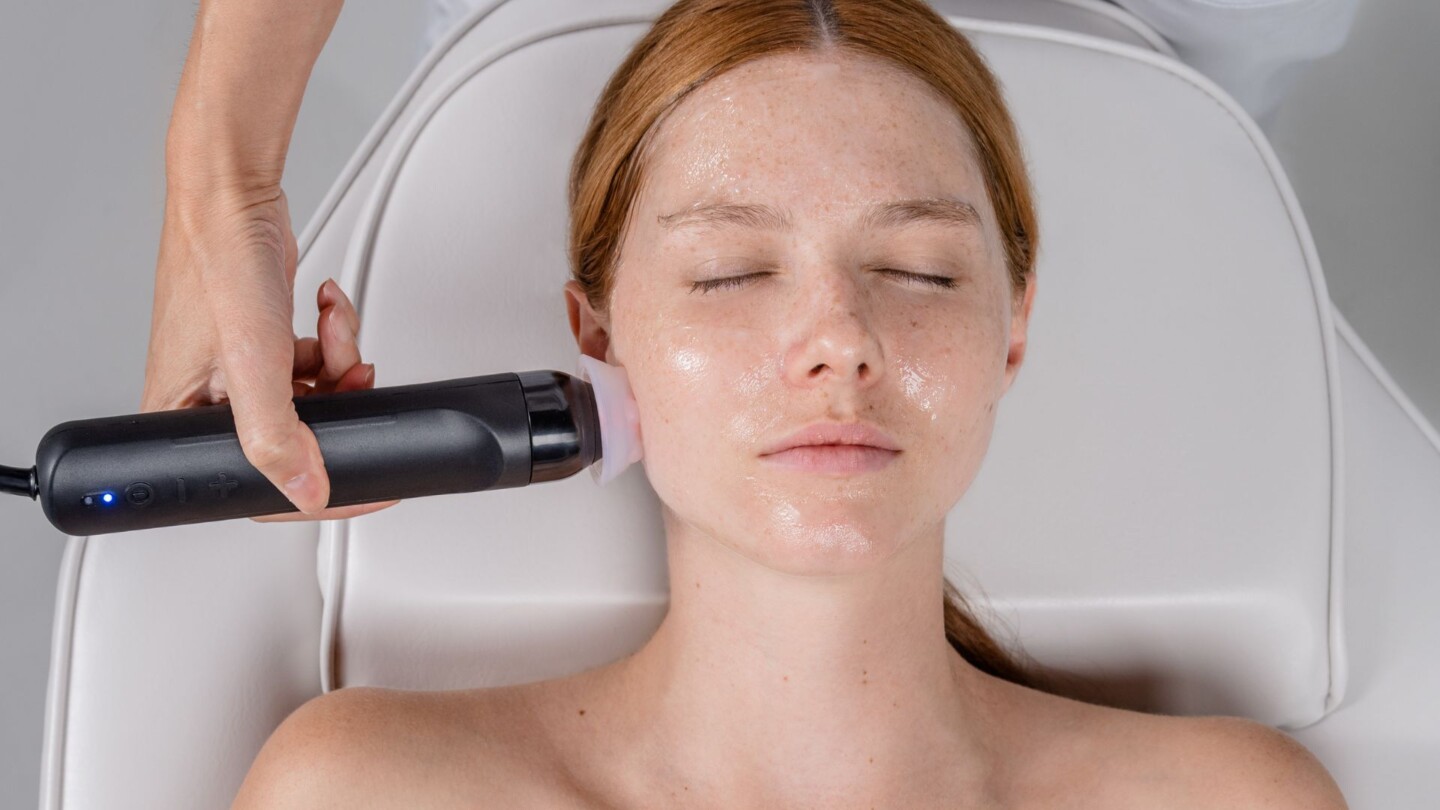 Woman receiving a Geneo facial treatment for skin rejuventation