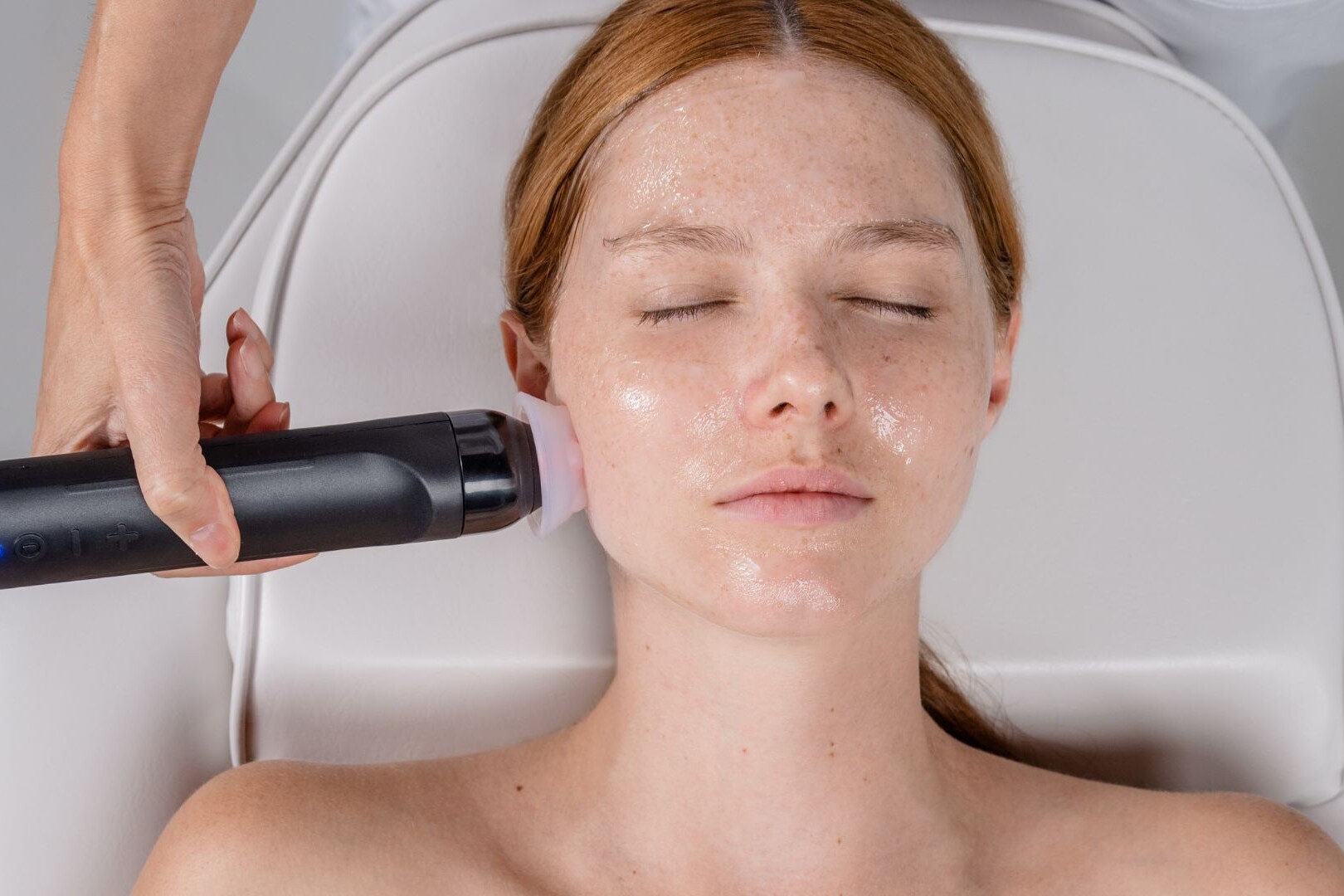 Woman receiving a Geneo facial treatment for skin rejuventation